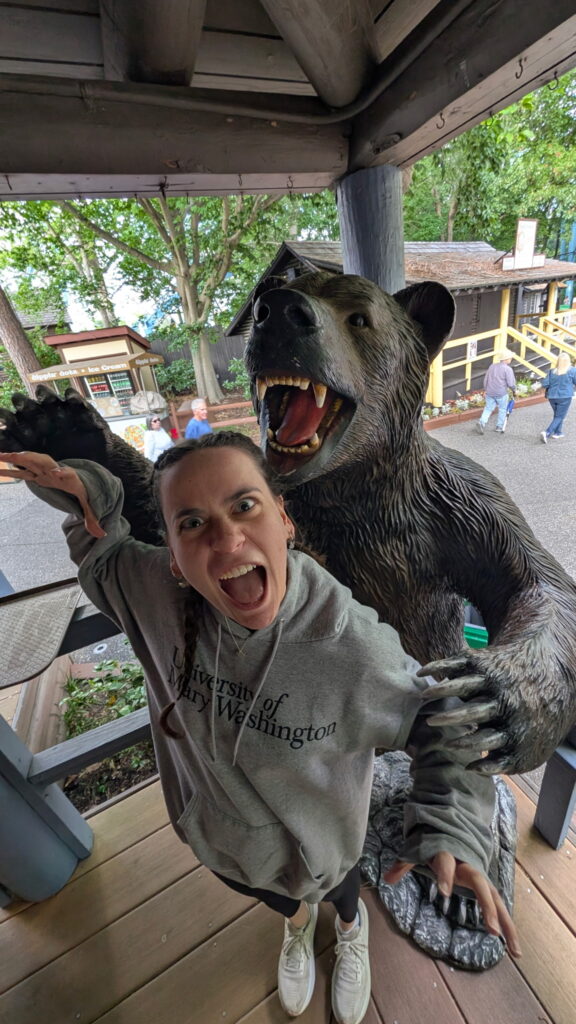 Kyra mimicking roaring bear statue